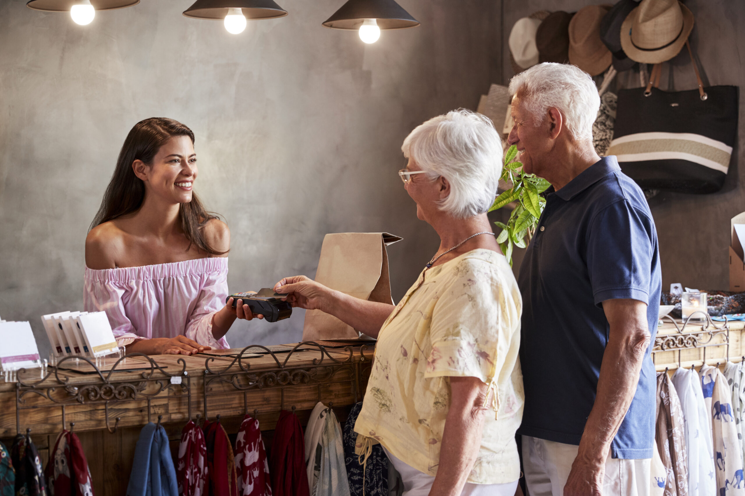 Senior Customers Buying Goods In Store Using Contactless Payment